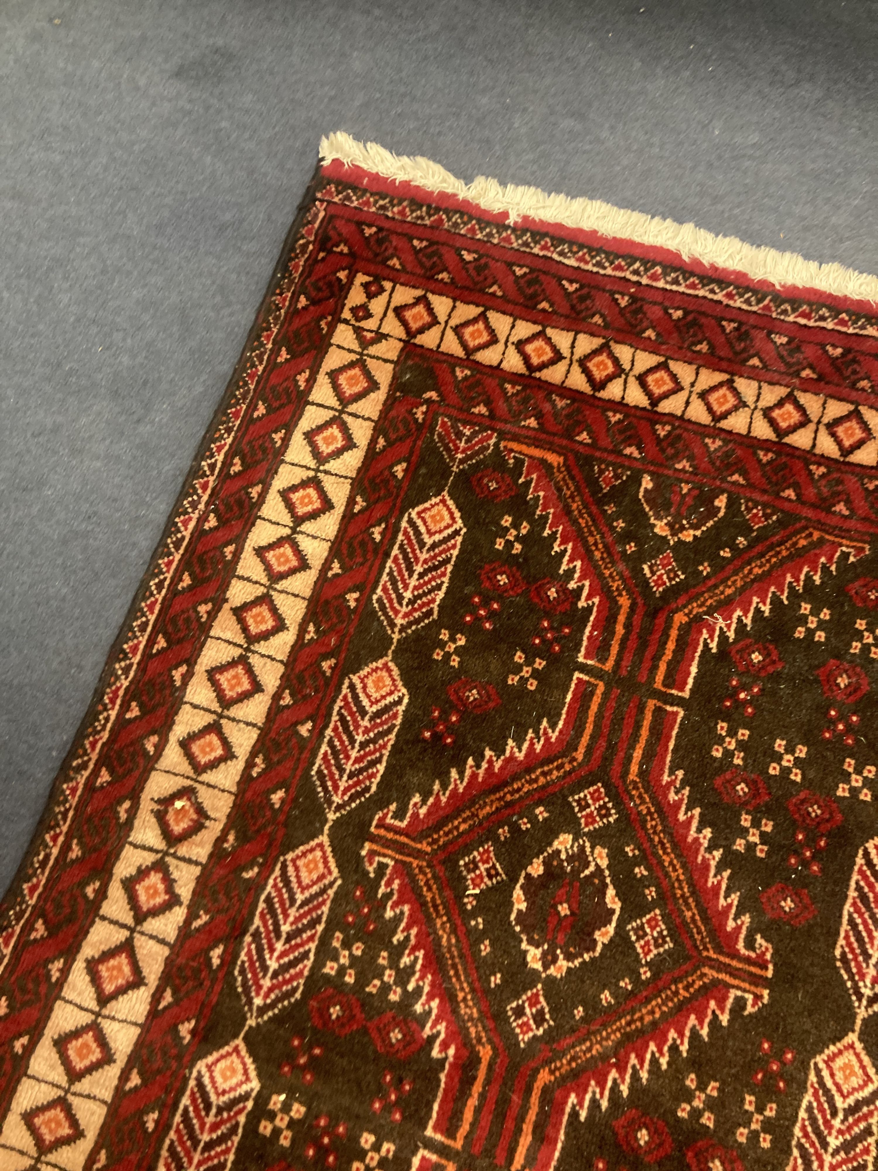 A Bakhtiari red ground rug, 210 x 110cm 210 x 110cm
